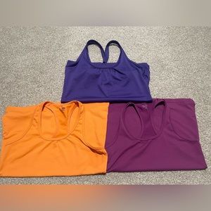 Champion workout tops, purple and orange.  Size small and medium.